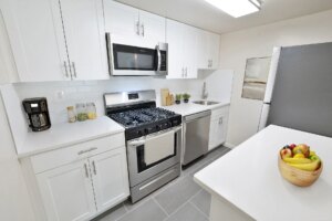 Clean bright modern kitchen with microwave and stove